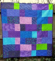 Multi-colored double slice pattern lap quilt